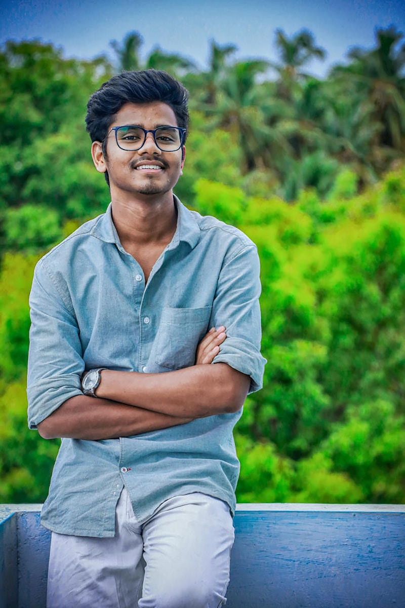 a man with his arms crossed sitting on a bench